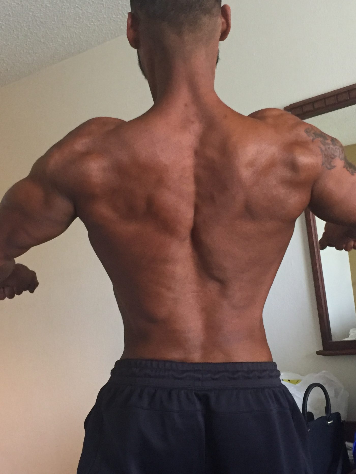 Diego showing off his back in his hotel room